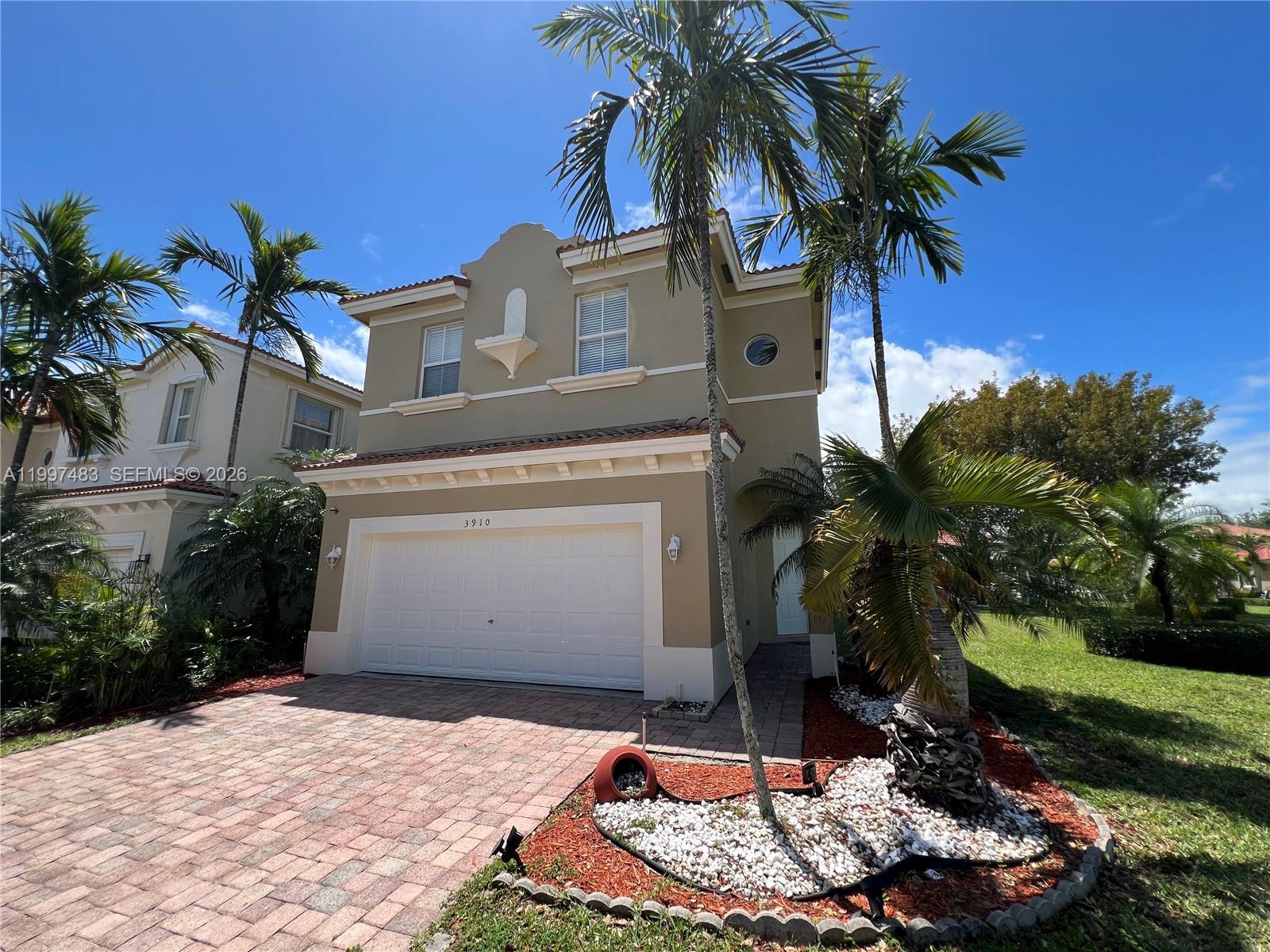 3910 Northeast 13th Drive Homestead, FL 33033 - Photo 2 of 35 a palm tree sitting in front of a house with a yard