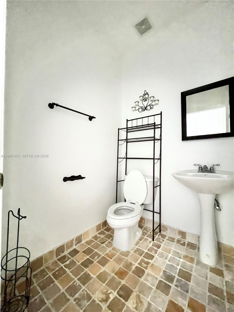 3910 Northeast 13th Drive Homestead, FL 33033 - Photo 21 of 35 a bathroom with a sink toilet and shower