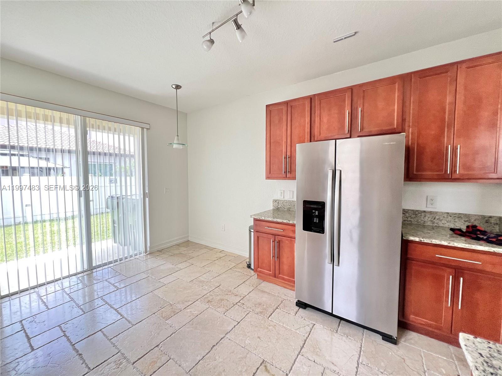 3910 Northeast 13th Drive Homestead, FL 33033 - Photo 27 of 35 a kitchen with stainless steel appliances a refrigerator and a stove top oven