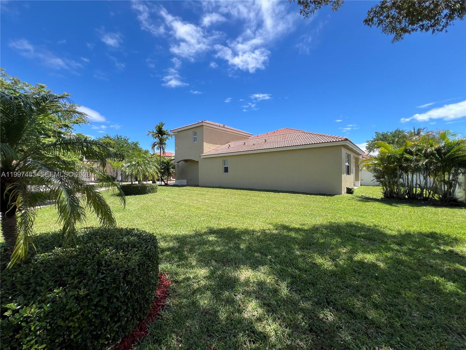 3910 Northeast 13th Drive Homestead, FL 33033 - Photo 3 of 35 a front view of a house with a yard