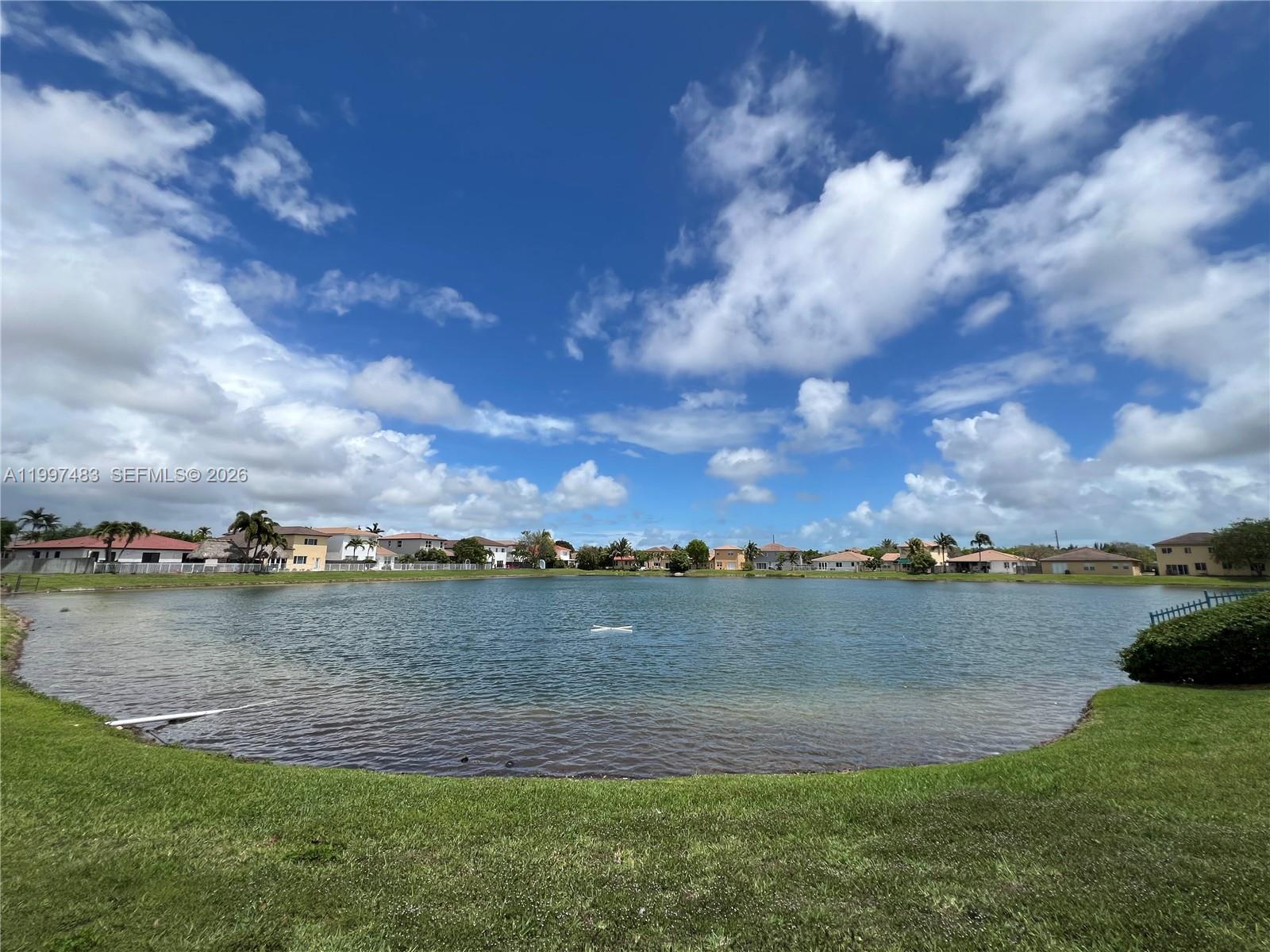 3910 Northeast 13th Drive Homestead, FL 33033 - Photo 32 of 35 a view of a lake with houses in the back