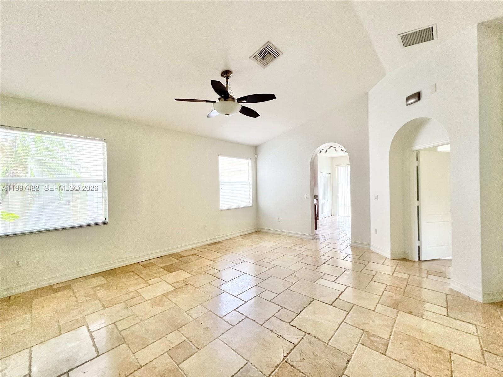 3910 Northeast 13th Drive Homestead, FL 33033 - Photo 5 of 35 a view of a room with a ceiling fan and window