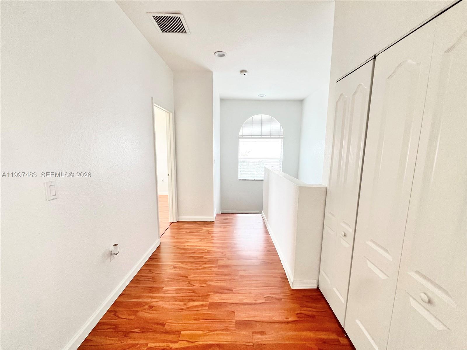 3910 Northeast 13th Drive Homestead, FL 33033 - Photo 8 of 35 a view of a hallway with wooden floor