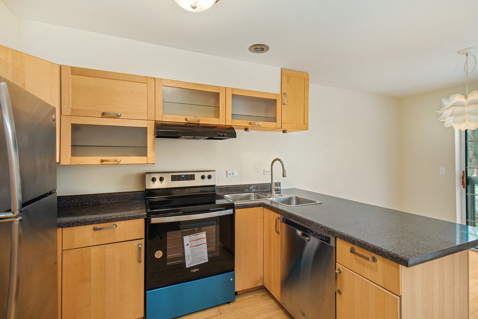 1334 South Lorraine Road, Unit F Wheaton, IL 60189 - Photo 3 of 12 a kitchen with stainless steel appliances granite countertop a stove and a sink