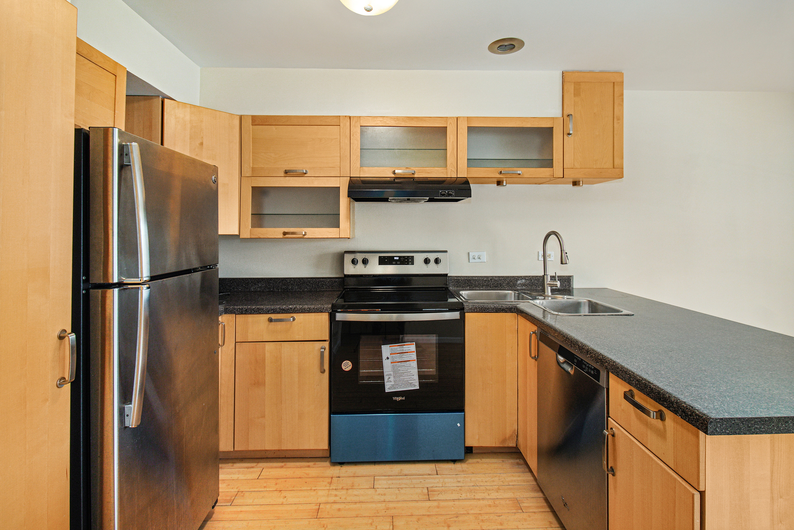 1334 South Lorraine Road, Unit F Wheaton, IL 60189 - Photo 4 of 12 a kitchen with stainless steel appliances granite countertop a refrigerator a stove and a sink