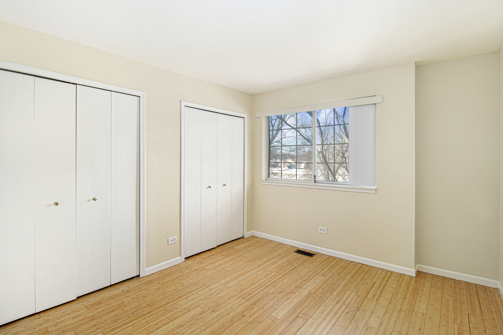 1334 South Lorraine Road, Unit F Wheaton, IL 60189 - Photo 10 of 12 an empty room with wooden floor and windows