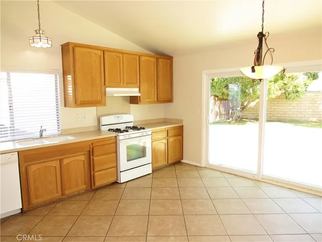 a kitchen with a stove a sink and a refrigerator