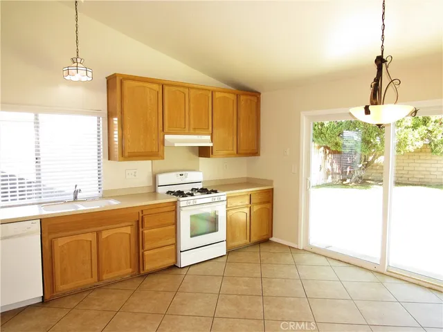 a kitchen with a stove a sink and a refrigerator