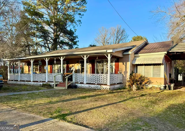 a front view of a house with a garden
