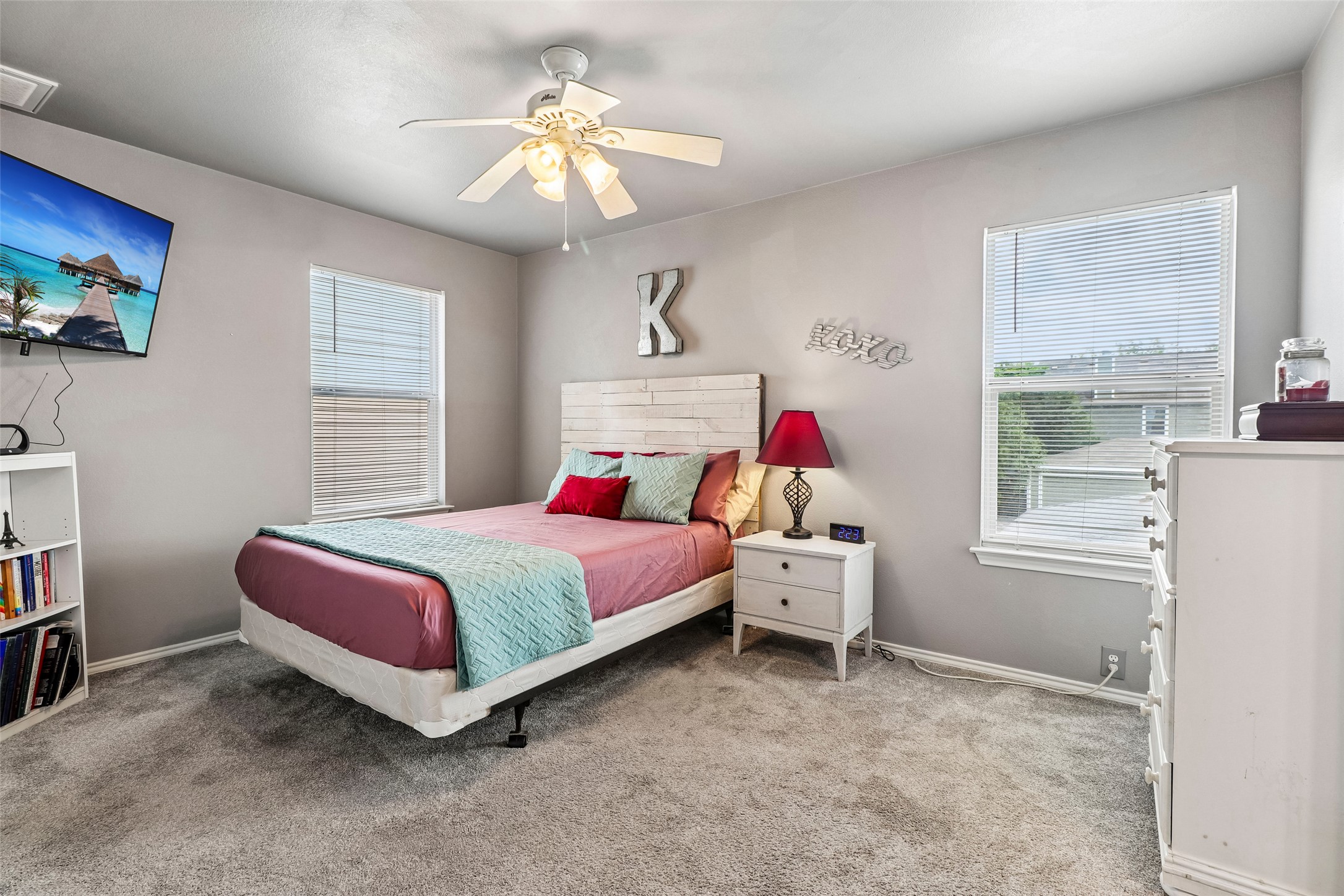 311 A Utterback Kyle, TX 78640 - Photo 16 of 40 a bedroom with a bed and a chandelier