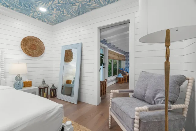 a bedroom with a bed and a painting on the wall