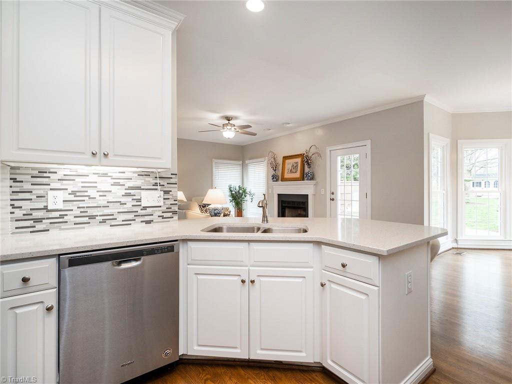 2811 Norwell Court Oak Ridge, NC 27310 - Photo 50 of 50 Open floor plan allows you to connect with family or guests in the living room while in the kitchen. All stainless steel appliances, updated backsplash, quartz counter tops and neutral welcoming colors.