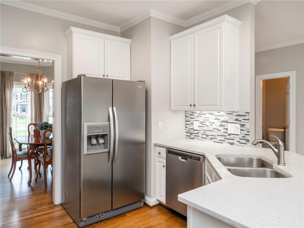 2811 Norwell Court Oak Ridge, NC 27310 - Photo 13 of 50 Kitchen offers direct access to dining room and is open to the main living areas of the home.