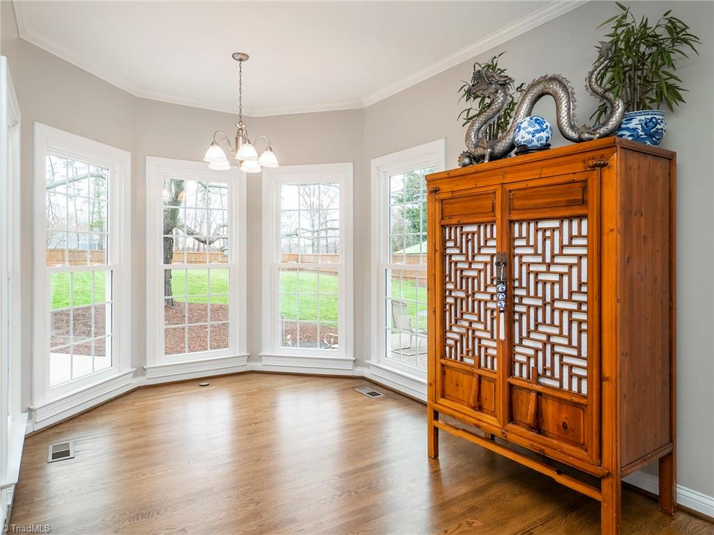 2811 Norwell Court Oak Ridge, NC 27310 - Photo 15 of 50 Five-sided Pella bay window in the breakfast nook lets in light from all angles and perfectly frames the majestic maple tree in the back yard.