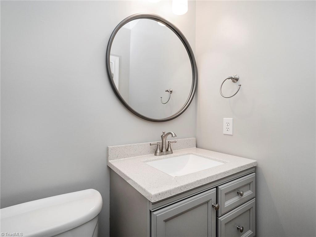 2811 Norwell Court Oak Ridge, NC 27310 - Photo 18 of 50 Renovated powder room on main with neutral pain colors, updated vanity and countertop, updated fixtures.