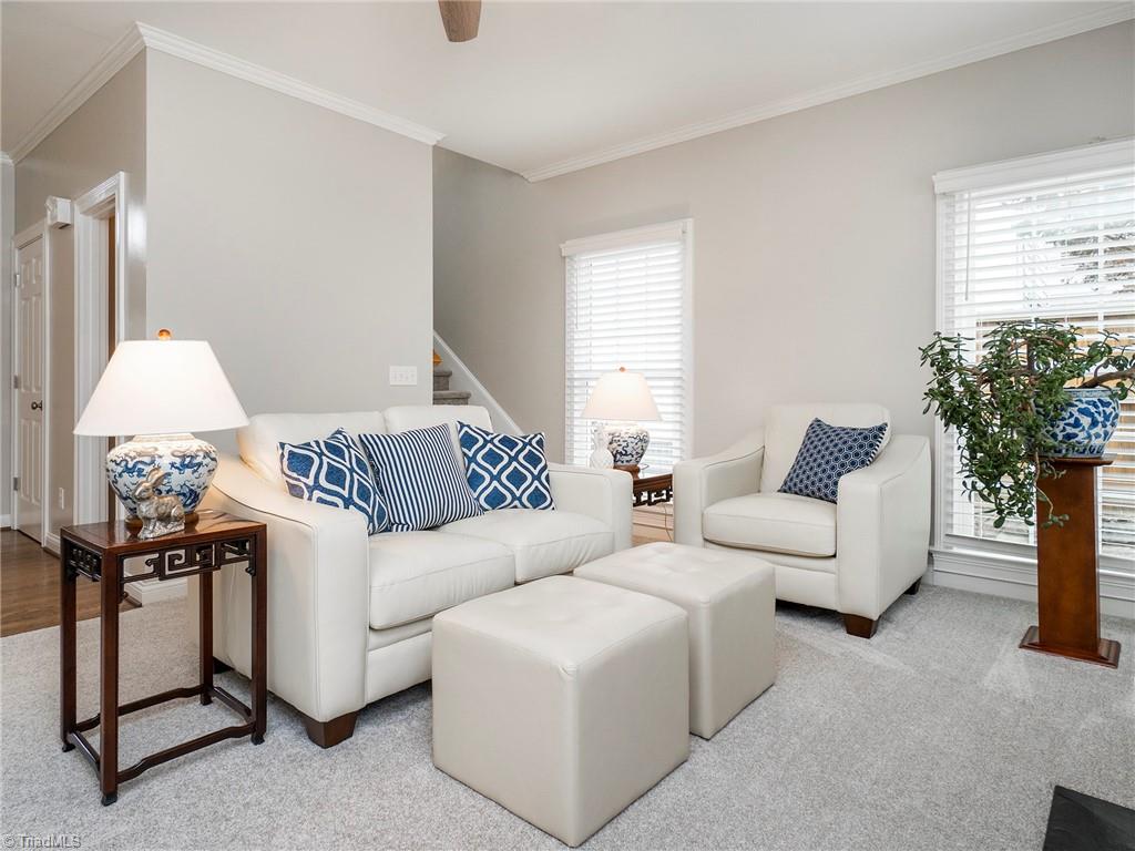 2811 Norwell Court Oak Ridge, NC 27310 - Photo 19 of 50 Family room with brand new carpet, gorgeous natural light, ceiling fan, open to kitchen and main entry way of the home.