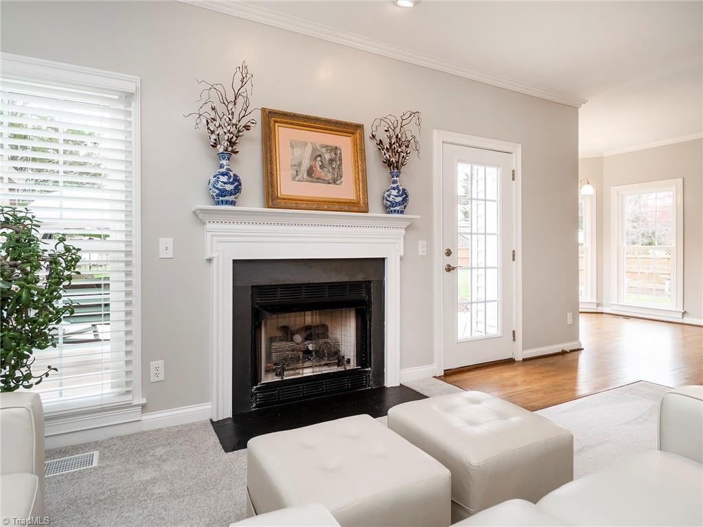 2811 Norwell Court Oak Ridge, NC 27310 - Photo 20 of 50 Showing off the oversized Pella windows and matching glass door, gas burning fireplace with detailed mantel