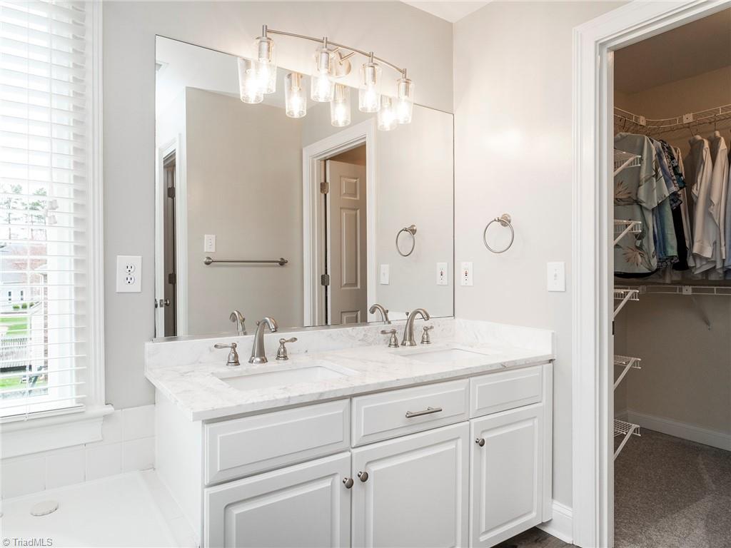 2811 Norwell Court Oak Ridge, NC 27310 - Photo 24 of 50 The newly renovated master bathroom, with marble vanity-top, new fixtures, and new grey flooring.