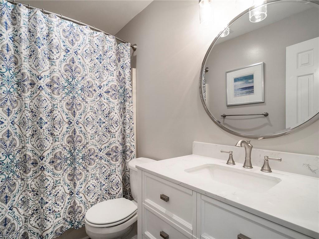2811 Norwell Court Oak Ridge, NC 27310 - Photo 30 of 50 Hall bath with shower/tub combo, updated vanity, countertops and fixtures.