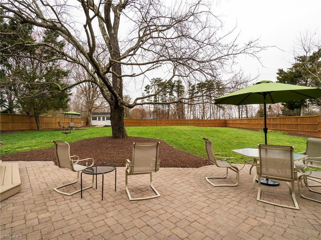 2811 Norwell Court Oak Ridge, NC 27310 - Photo 40 of 50 Overlooking the backyard with beautiful landscaping that offers wonderful shade in the spring and summer.