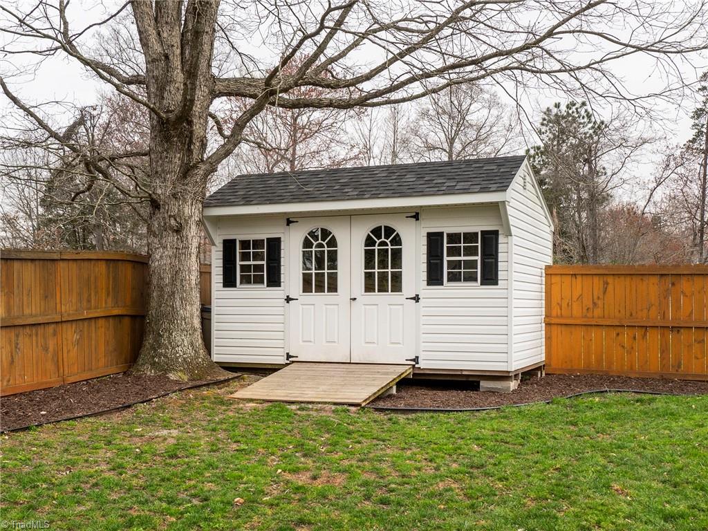 2811 Norwell Court Oak Ridge, NC 27310 - Photo 41 of 50 10x14 storage building at the back of the fenced area of the home. Perfect for storing yard tools, gardening tools and anything else needed for the backyard.