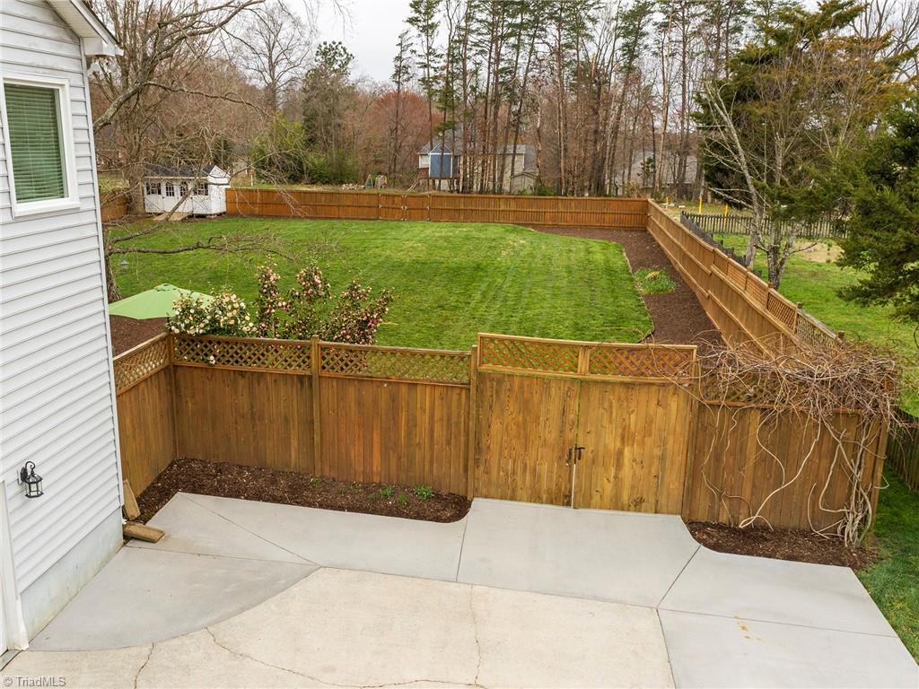 2811 Norwell Court Oak Ridge, NC 27310 - Photo 47 of 50 Oversized Driveway! Perfect for parking multiple cars! The home offers a side loading garage and the gate to the backyard at the driveway offers double opening to move larger items into the backyard.