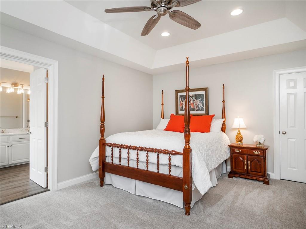 2811 Norwell Court Oak Ridge, NC 27310 - Photo 7 of 50 Spacious primary with new carpet, tray ceiling, large closets and updated bath.