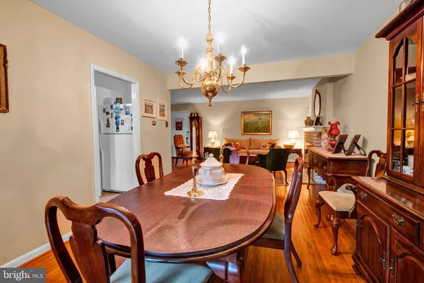 a dining room with furniture a chandelier and window