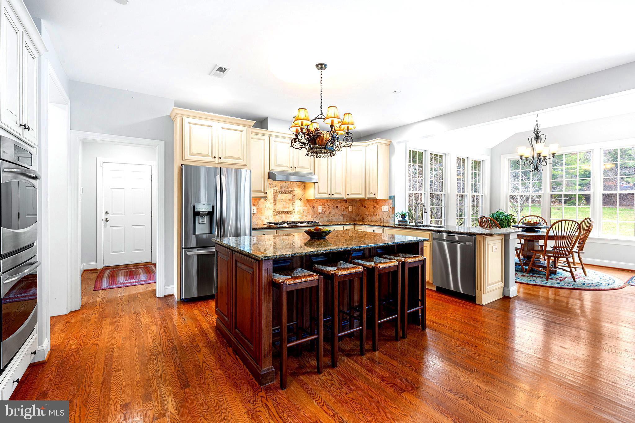 371 Trillium Lane Wayne, PA 19087 - Photo 14 of 43 a kitchen with stainless steel appliances granite countertop a stove and a view of living room