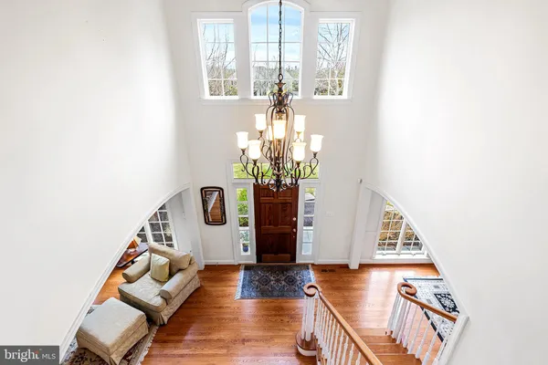 a view of a living room with furniture and a chandelier