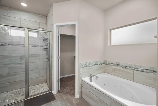 a bathroom with a bathtub and a shower