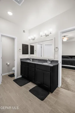 a spacious bathroom with a sink a mirror and a bathtub