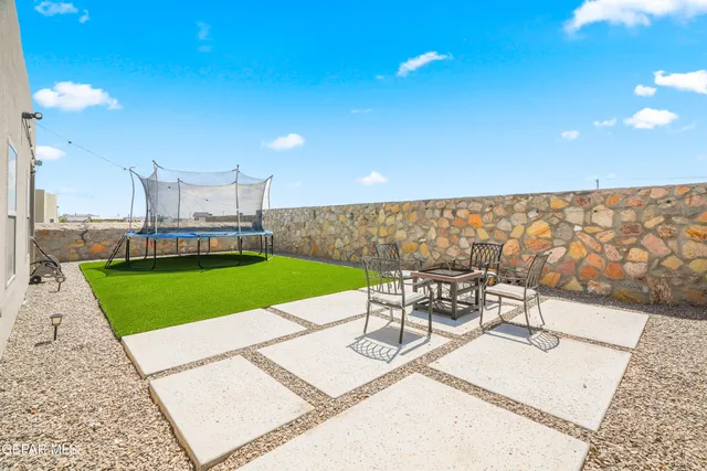 a view of a patio with a table and chairs