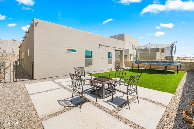 a view of a patio with a table and chairs