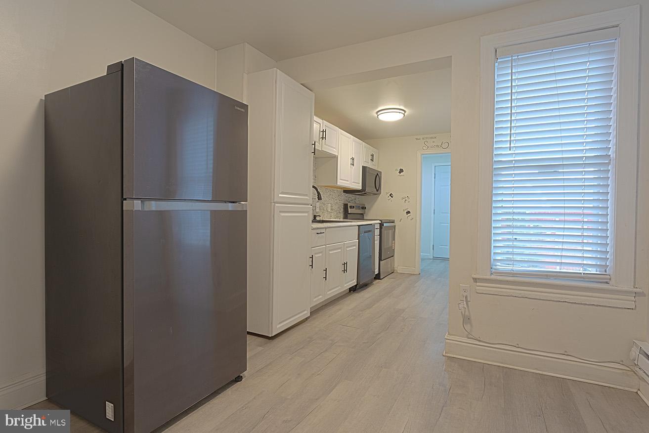 417 North 2nd Street Reading, PA 19601 - Photo 6 of 22 a kitchen with stainless steel appliances white cabinets and a refrigerator