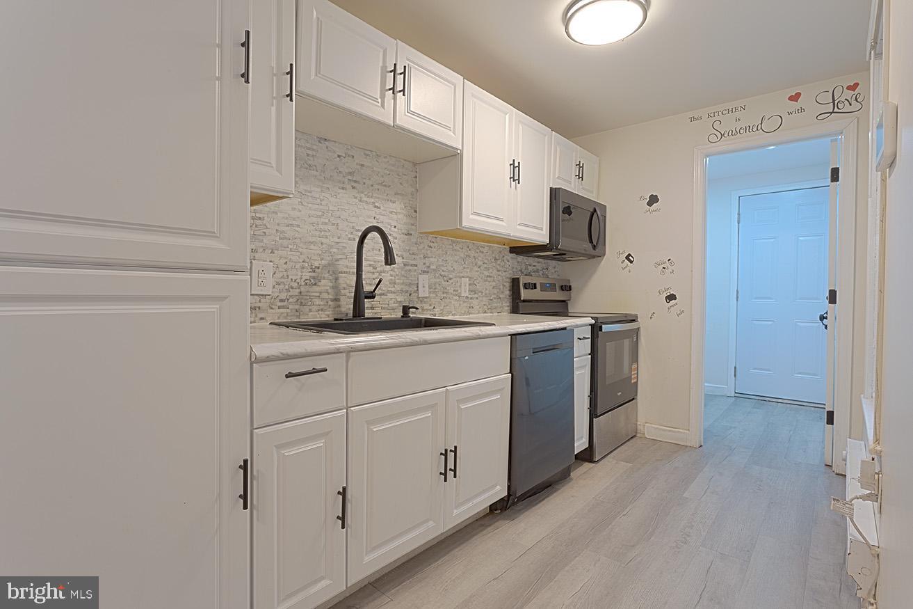 417 North 2nd Street Reading, PA 19601 - Photo 8 of 22 a kitchen with white cabinets and white appliances