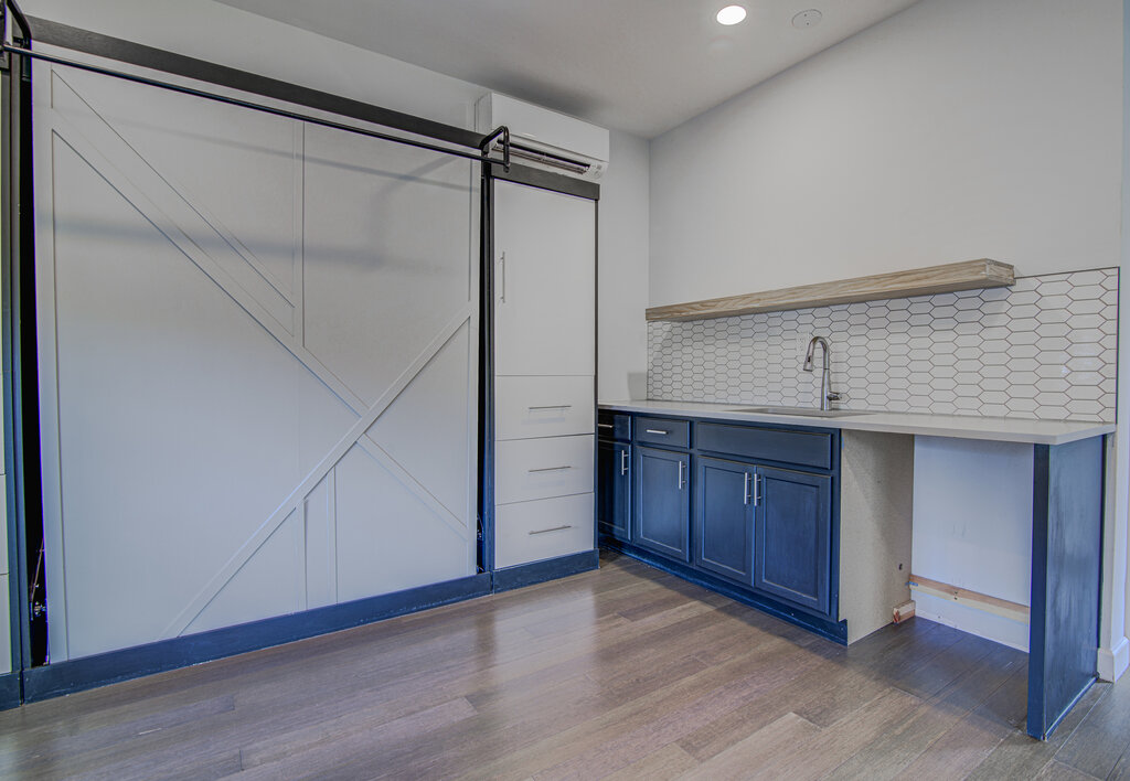 2406 East 16th Street Austin, TX 78702 - Photo 37 of 39 a view of an empty room with wooden floor and cabinet