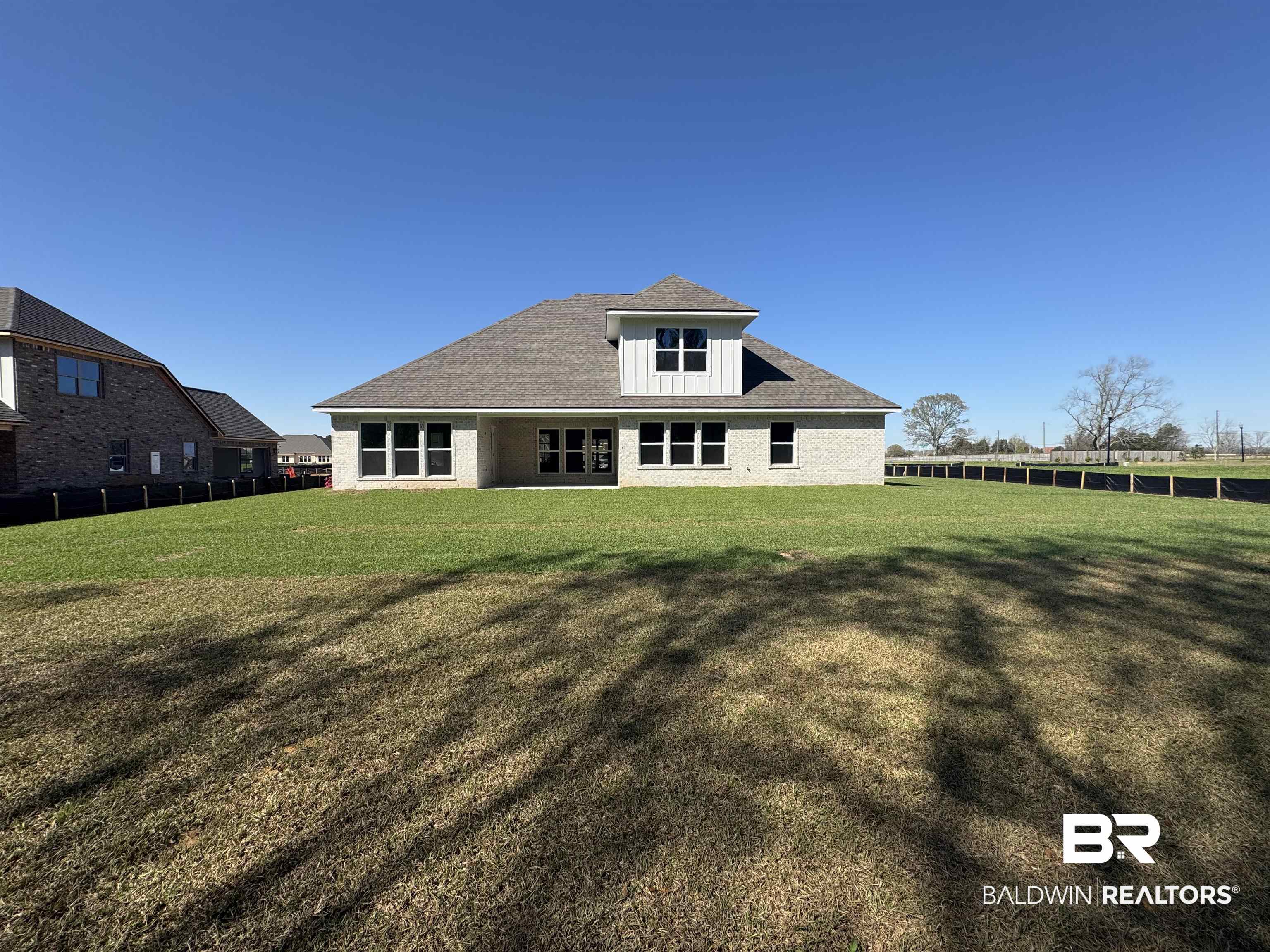 302 Morning Mist Way Fairhope, AL 36532 - Photo 6 of 33 Rear view of house with a yard and fence