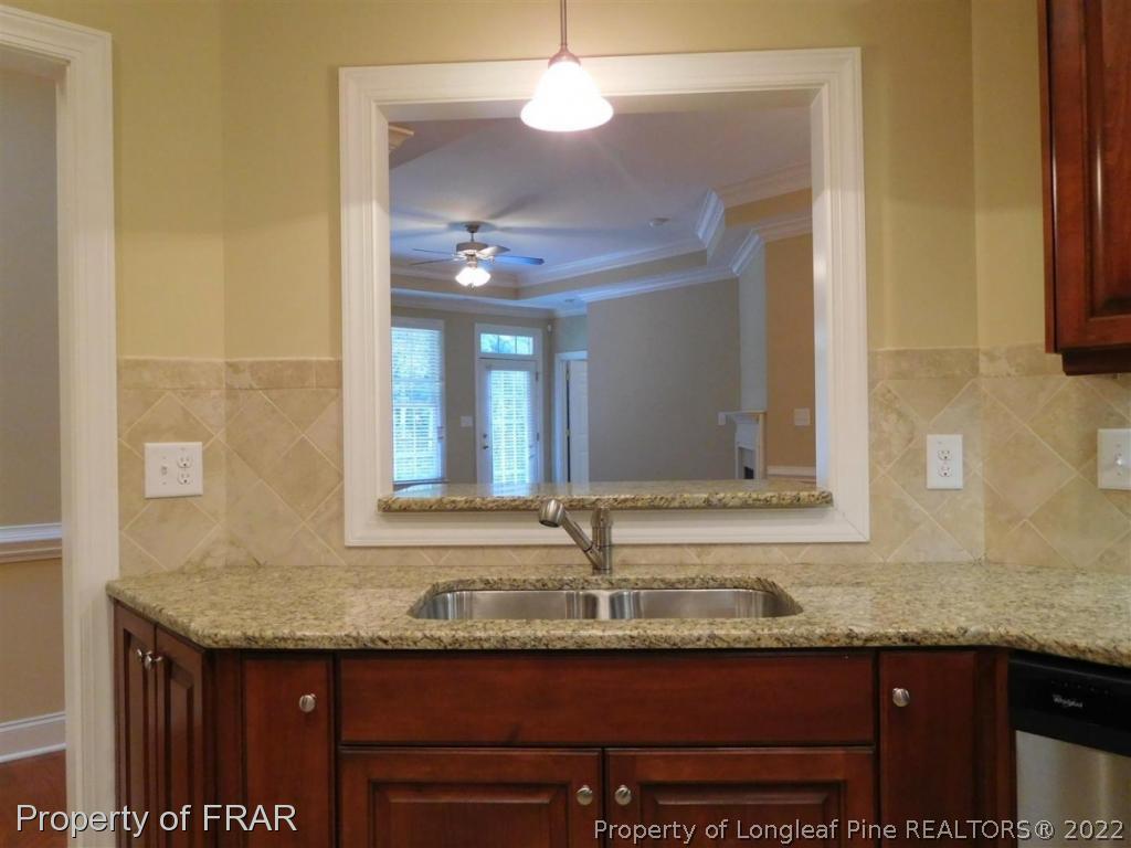 2641 Lockwood Road, Unit 202 Fayetteville, NC 28303 - Photo 11 of 36 a bathroom with granite countertop a sink and a mirror