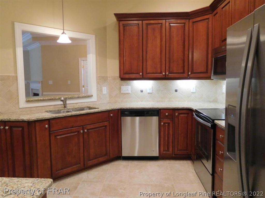 2641 Lockwood Road, Unit 202 Fayetteville, NC 28303 - Photo 12 of 36 a kitchen with stainless steel appliances granite countertop wooden cabinets a sink and dishwasher
