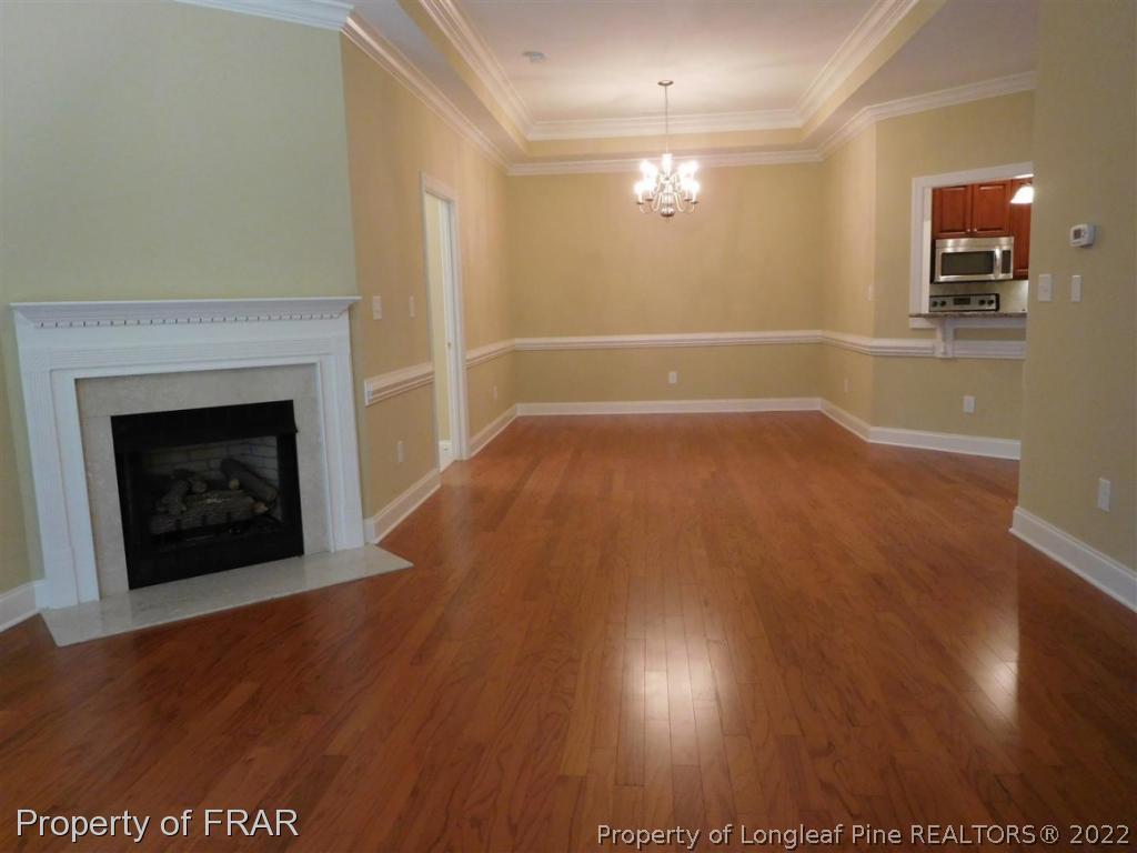 2641 Lockwood Road, Unit 202 Fayetteville, NC 28303 - Photo 18 of 36 a view of empty room with wooden floor and fireplace