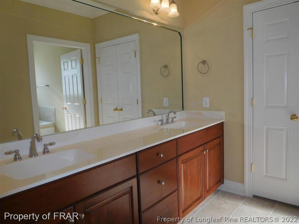 2641 Lockwood Road, Unit 202 Fayetteville, NC 28303 - Photo 22 of 36 a bathroom with a sink double vanity and a mirror