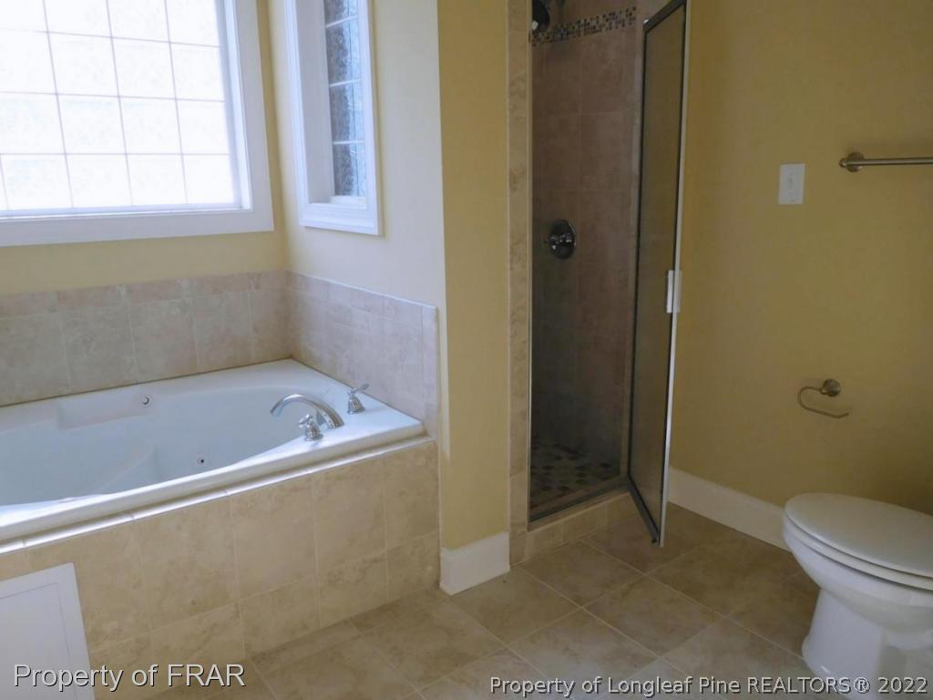 2641 Lockwood Road, Unit 202 Fayetteville, NC 28303 - Photo 23 of 36 a bathroom with a bath tub and a shower