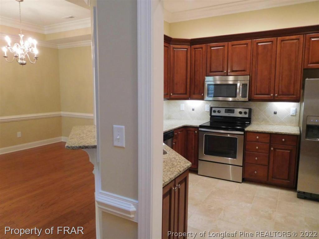 2641 Lockwood Road, Unit 202 Fayetteville, NC 28303 - Photo 8 of 36 a kitchen with stainless steel appliances granite countertop a refrigerator stove and microwave