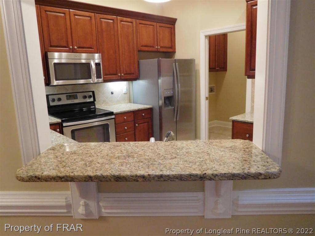 2641 Lockwood Road, Unit 202 Fayetteville, NC 28303 - Photo 9 of 36 a kitchen with stainless steel appliances granite countertop a refrigerator a stove and oven