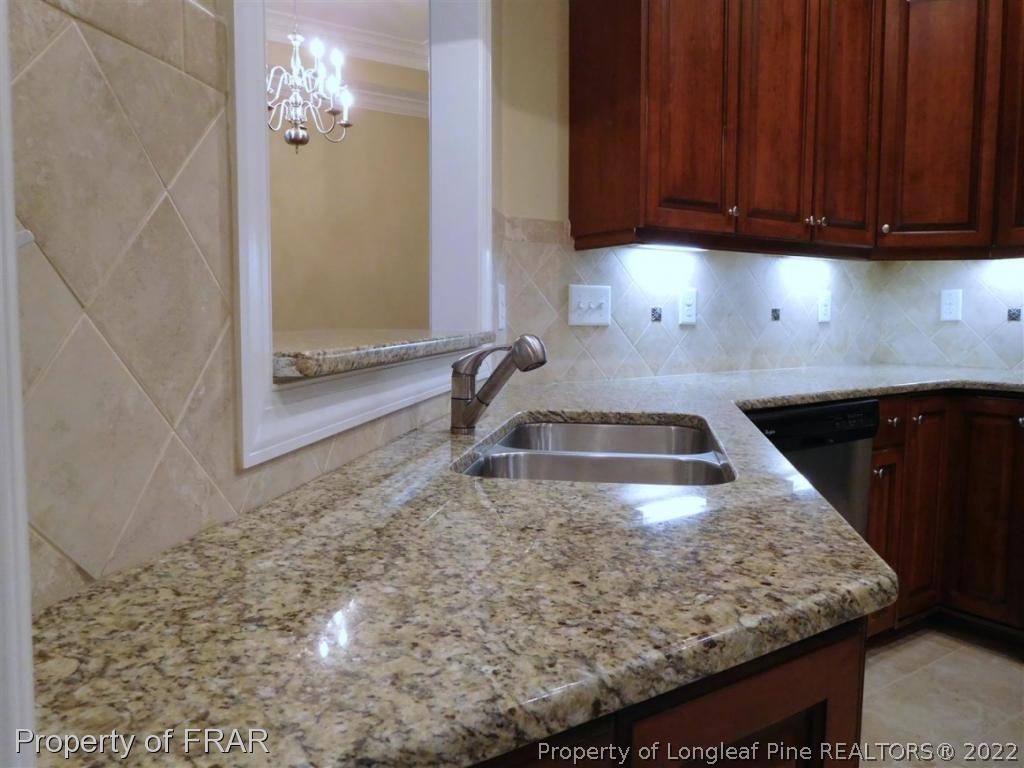 2641 Lockwood Road, Unit 202 Fayetteville, NC 28303 - Photo 10 of 36 a kitchen with a sink a stove and cabinets