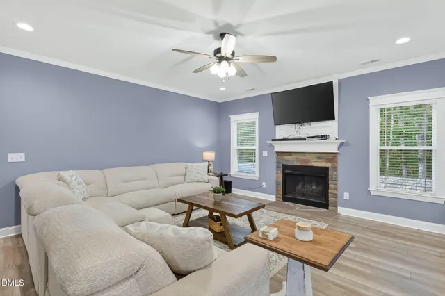 a living room with furniture fireplace and a flat screen tv