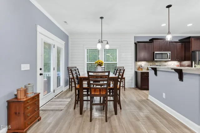 a view of a dining room with furniture and chandelier
