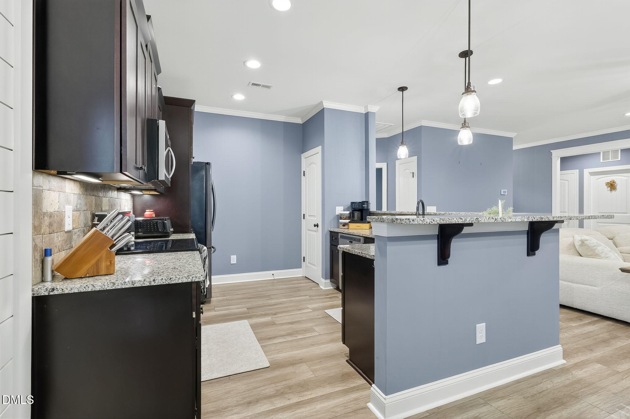 238 Deer Path Farms Road Erwin, NC 28339 - Photo 25 of 49 a kitchen with kitchen island a counter top space appliances and a ceiling fan
