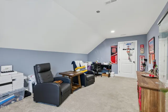 a bedroom with furniture and a chair